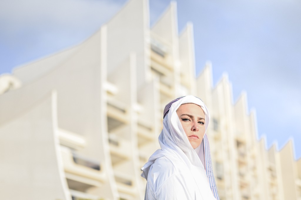 Photography by Hugo Landais, portrait in white against sculptural white architecture.