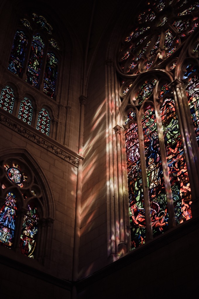 Photography by Hugo Landais, Gothic cathedral interior, stained glass light on stone.